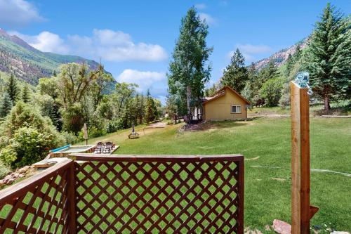 a view of a backyard from a wooden fence at Elephant Mountain Cabin at Filoha Meadows in Redstone