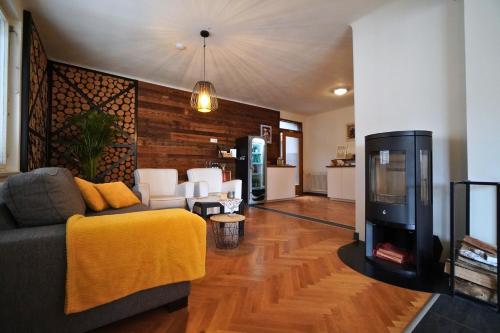 a living room with a couch and a tv at Pension Sonnenheim in Gmünd in Kärnten