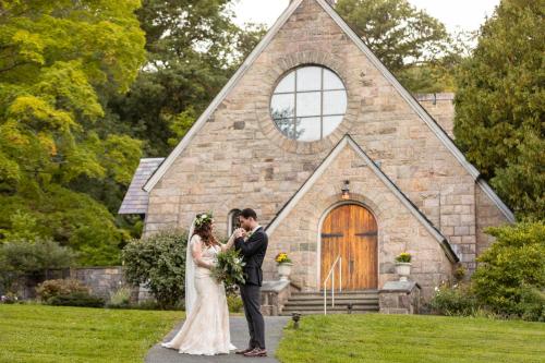 a bride and groom standing in front of a church at Silver Bay YMCA Inn and Conference Center in Silver Bay