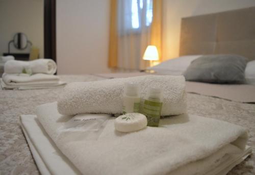 a pile of towels on a bed in a bedroom at Villa Dabac in Sveti Juraj