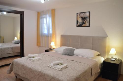 a bedroom with a bed with two towels on it at Villa Dabac in Sveti Juraj