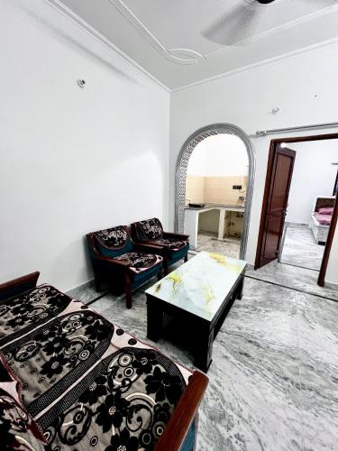 a living room with two beds and a couch at Aanandit aashiyana - A Blissful Place in Dehradun