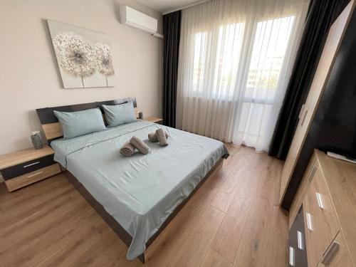 a bedroom with a bed with two towels on it at 2BR central escape in Varna City