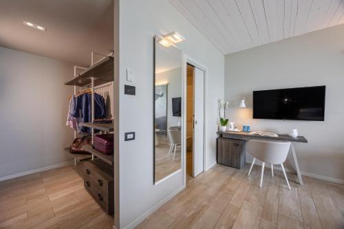 a room with a desk and a sliding glass door at Nautilus Family Hotel in Pesaro