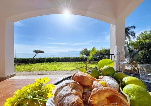 a plate of bread on a table with a view at Solemar Sicilia - Ville Paradiso in Santa Flavia