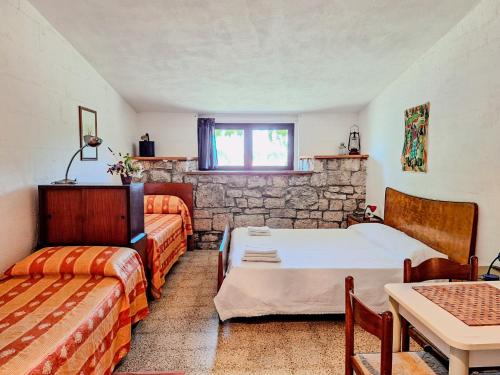 a room with a bed and a couch and a table at Masseria PietraViva in Altamura