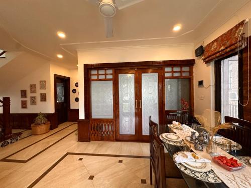 a dining room with a table and chairs in a room at Silver Woods- A Boutique Cottage in Srinagar