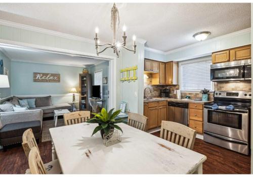 a kitchen and living room with a table and chairs at Relaxing Condo for 6 in Popular Hilton Head Resort in Hilton Head Island
