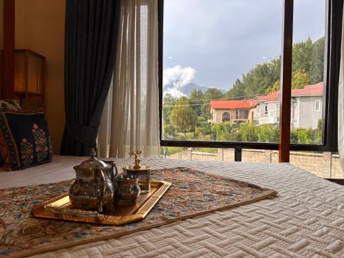 a bed with a tray on it with a window at Silver Woods- A Boutique Cottage in Srinagar