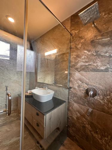 a bathroom with a sink and a shower at Silver Woods- A Boutique Cottage in Srinagar