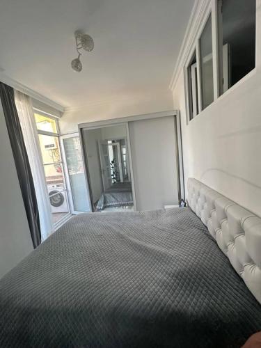 a bedroom with a large bed and a large mirror at ბინა დღიურად in Kakhaberi
