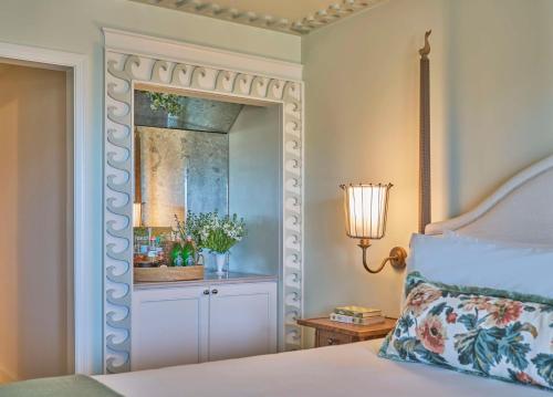 a bedroom with a bed with a mirror at The Sanderling in Duck