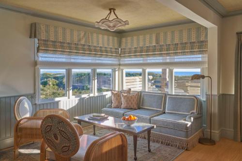 a living room with a couch and a table at The Sanderling in Duck