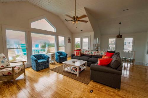 a living room with a couch and a table at The Sanderling in Duck