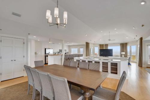a kitchen and dining room with a table and chairs at The Sanderling in Duck