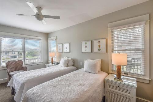 a bedroom with two beds and a ceiling fan at The Sanderling in Duck