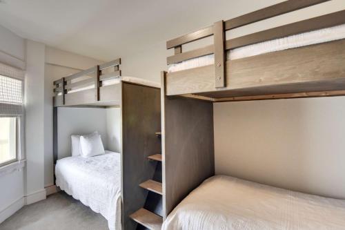 a bedroom with two bunk beds and a bed at The Sanderling in Duck