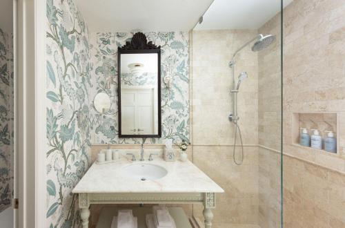 a bathroom with a sink and a shower at The Sanderling in Duck