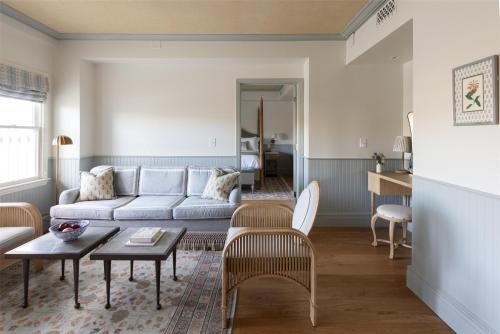 a living room with a couch and a table at The Sanderling in Duck