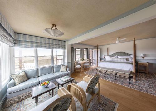 a living room with a bed and a couch at The Sanderling in Duck