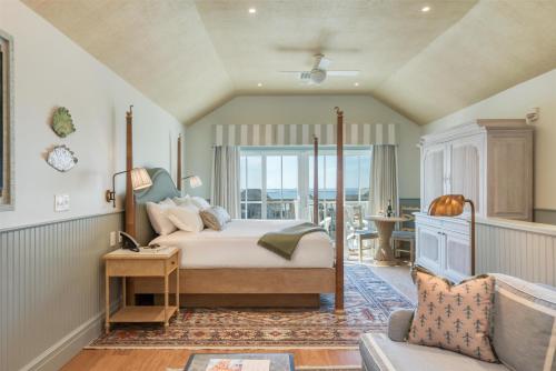 a bedroom with a bed with a view of the ocean at The Sanderling in Duck