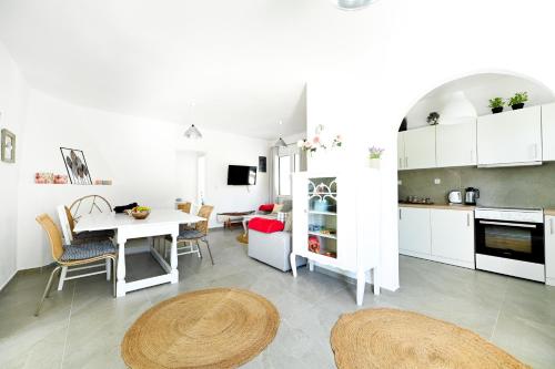 a kitchen and dining room with a table and chairs at Anchor Villa in Troulos
