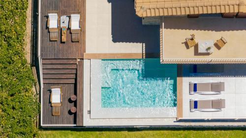 an overhead view of a house with a swimming pool at Arca Villa - Enchanting Sunset! in Keri
