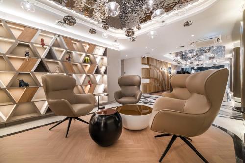 a hair salon with two chairs and a vase at Wings Plaza in Kraków