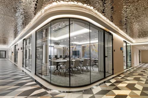 a room with glass doors and a table with chairs at Wings Plaza in Kraków