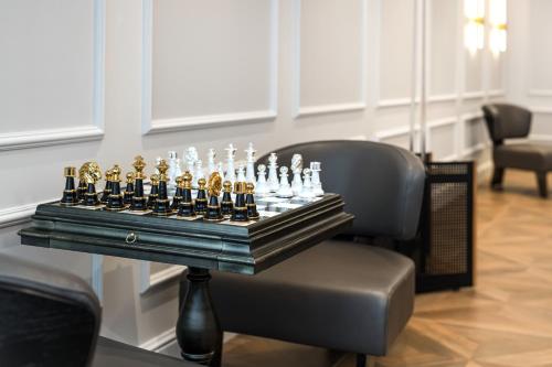 a chess set on a table on a chair at Wings Plaza in Kraków