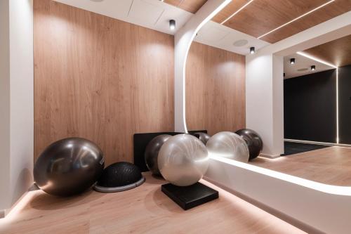 a room with three large metal spheres on a wooden floor at Wings Plaza in Kraków