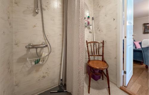 a wooden chair in a bathroom with a shower at 3 Bedroom Cozy Home In Nässjö in Nässjö