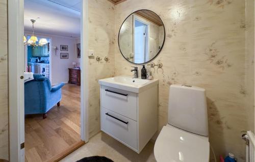 a bathroom with a toilet and a sink and a mirror at 3 Bedroom Cozy Home In Nässjö in Nässjö