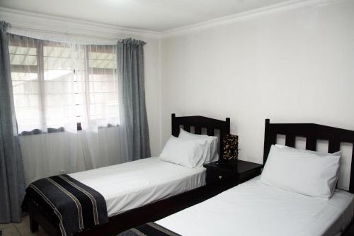 Ένα ή περισσότερα κρεβάτια σε δωμάτιο στο Nwabu Lodge Sodwana Bay