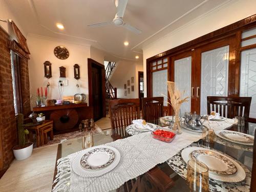 a dining room with a table with plates on it at Silver Woods- A Boutique Cottage in Srinagar