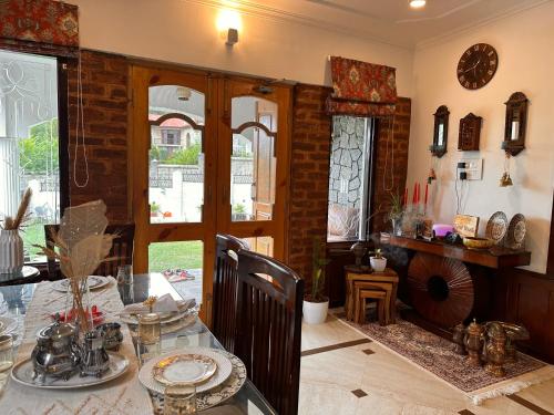 a dining room with a table and a dining room at Silver Woods- A Boutique Cottage in Srinagar