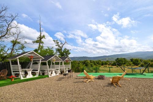 a playground with chairs and a house with a green at ALLIANCE Hotel NEW 2025 -Breakfast and pool included in Solotvyno