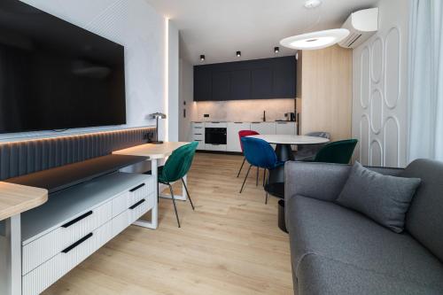 a living room with a couch and a tv at Wings Plaza in Kraków