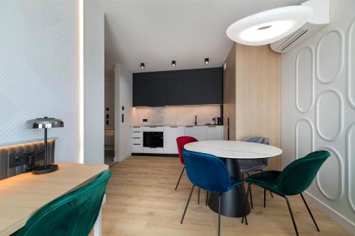 a kitchen and dining room with a table and chairs at Wings Plaza in Kraków