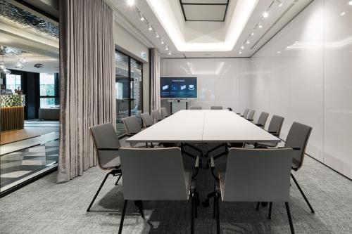 a conference room with a white table and chairs at Wings Plaza in Kraków