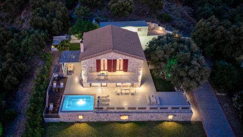 an aerial view of a house with a swimming pool at Arca Villa - Enchanting Sunset! in Keri
