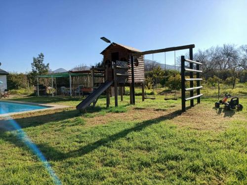 a playground with a slide next to a pool at Rincon del Campo in La Serena