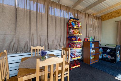 a dining room with a table and chairs and a curtain at Dana NEW 2025 in Solotvyno