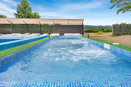 a swimming pool with blue water in a yard at Dana NEW 2025 in Solotvyno