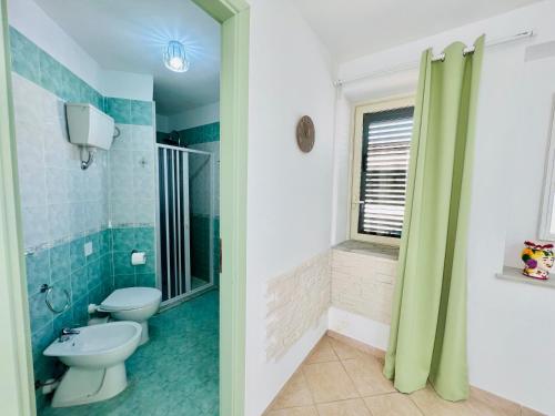 a bathroom with a toilet and a shower at Palmira in Isola delle Femmine