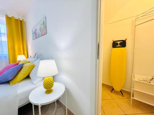 a bedroom with a bed and a table with a lamp at Palmira in Isola delle Femmine