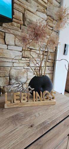 a wooden sign that says exit with a plant at Home sweet Home in Havelberg