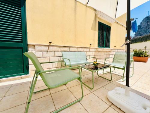 two chairs and a table on a patio at Palmira in Isola delle Femmine