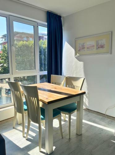 a dining room with a wooden table and chairs at STELA in Nesebar