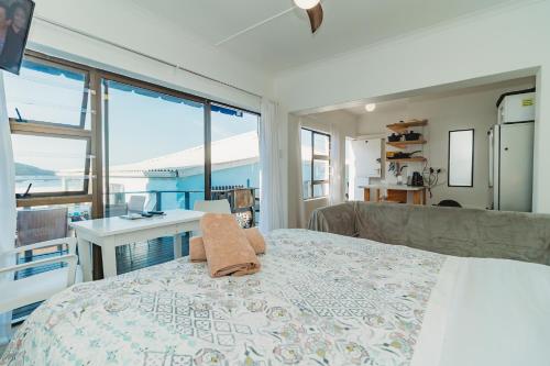 a bedroom with a bed with a view of the ocean at Silver Spray Beach Accommodation in Victoria Bay